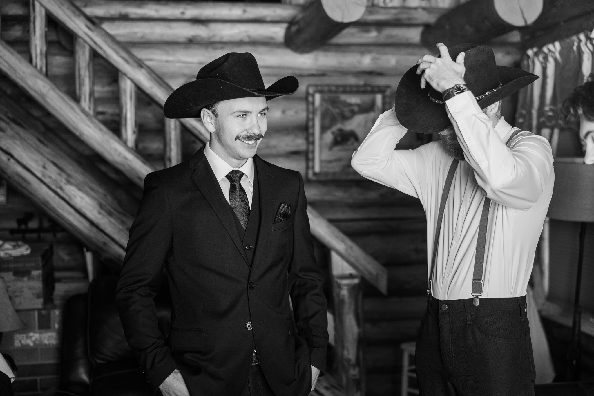 Groom getting ready detail, rustic log cabin