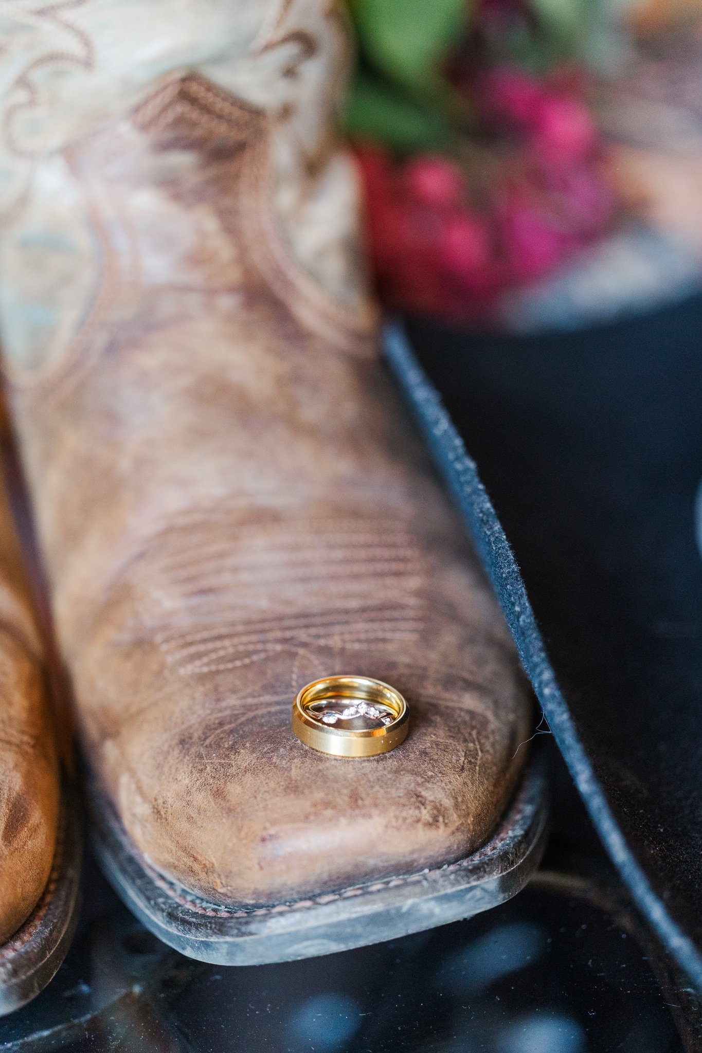 Groom in cowboy boots and suspenders on wedding morning