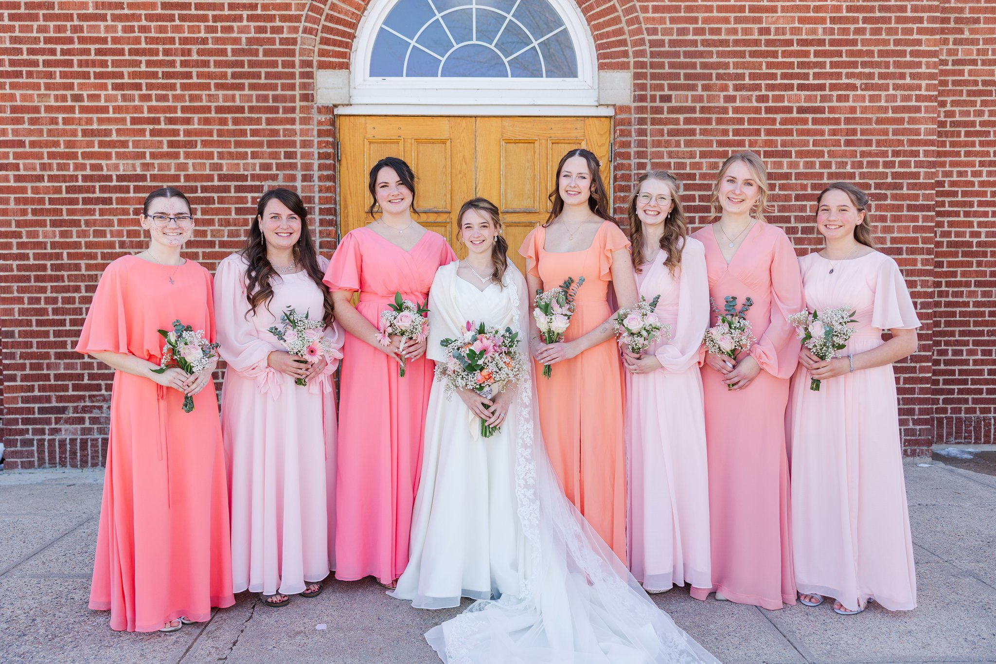 Wedding party group portrait with bride and groom