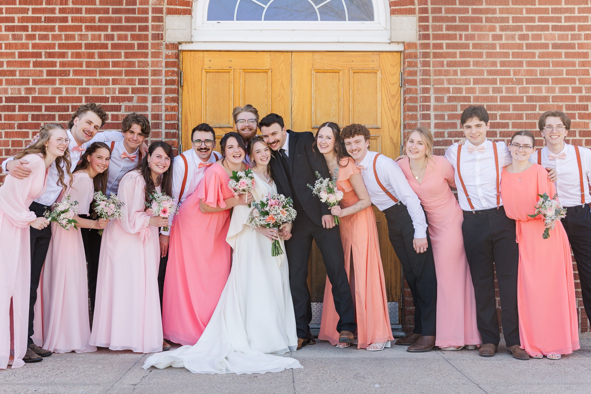 Bridesmaids portrait in coral dresses with the bride