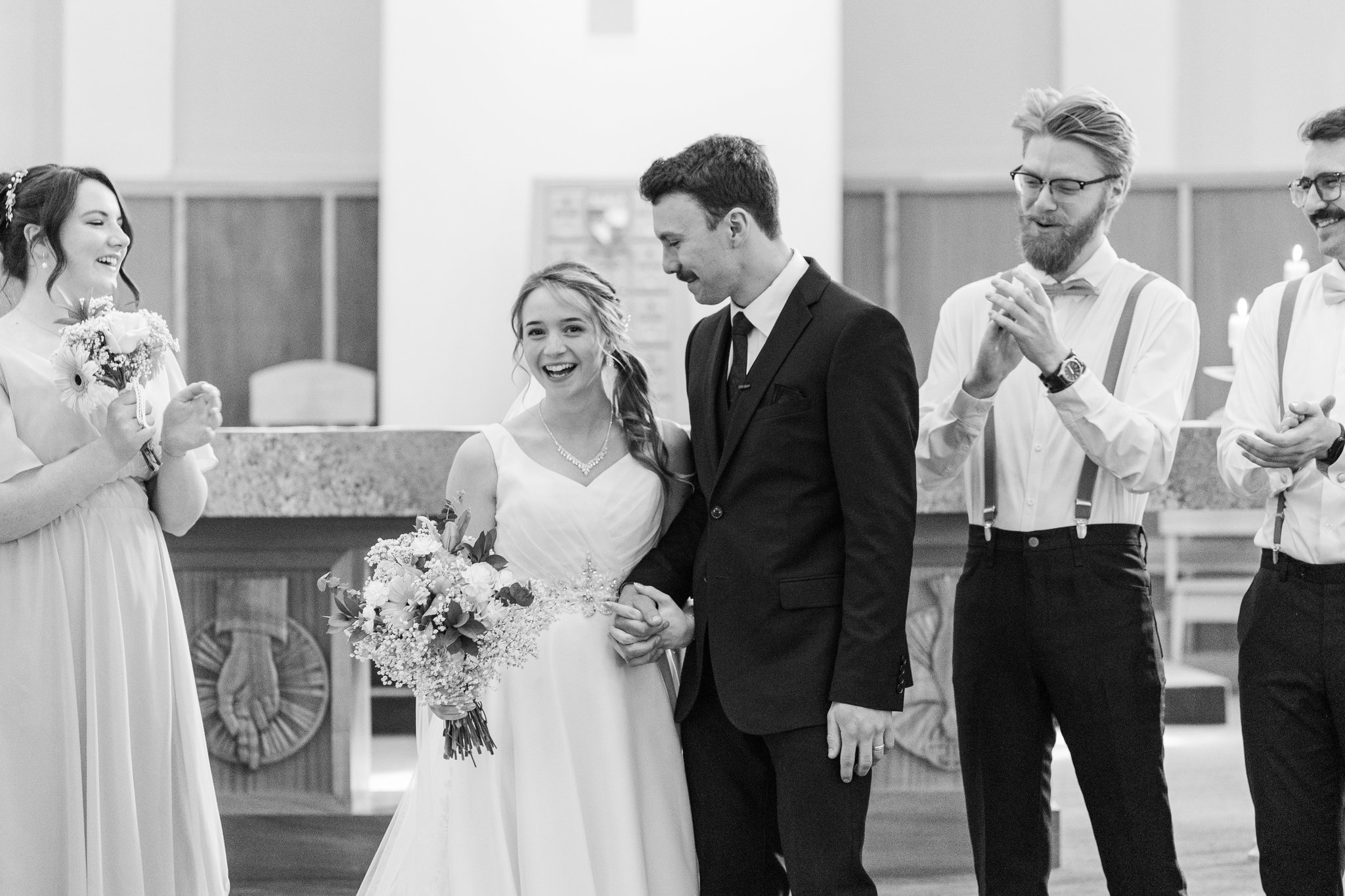 Guests cheering for bride and groom during the recessional