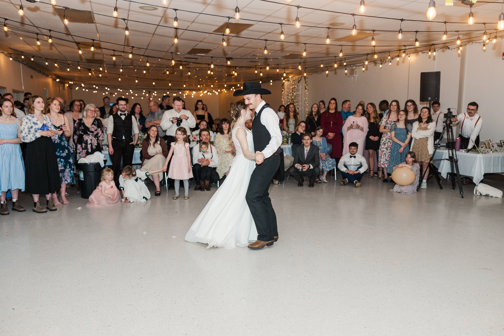Wedding guests dancing together on the dance floor