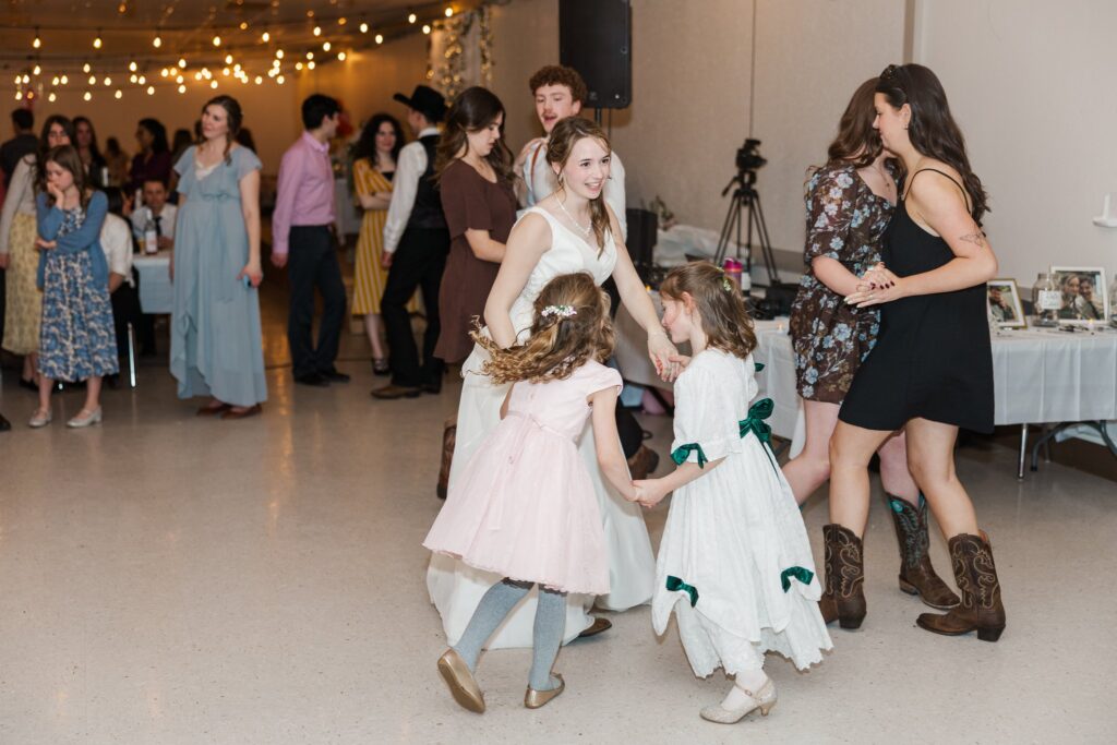 Wide shot of all guests dancing at the wedding reception