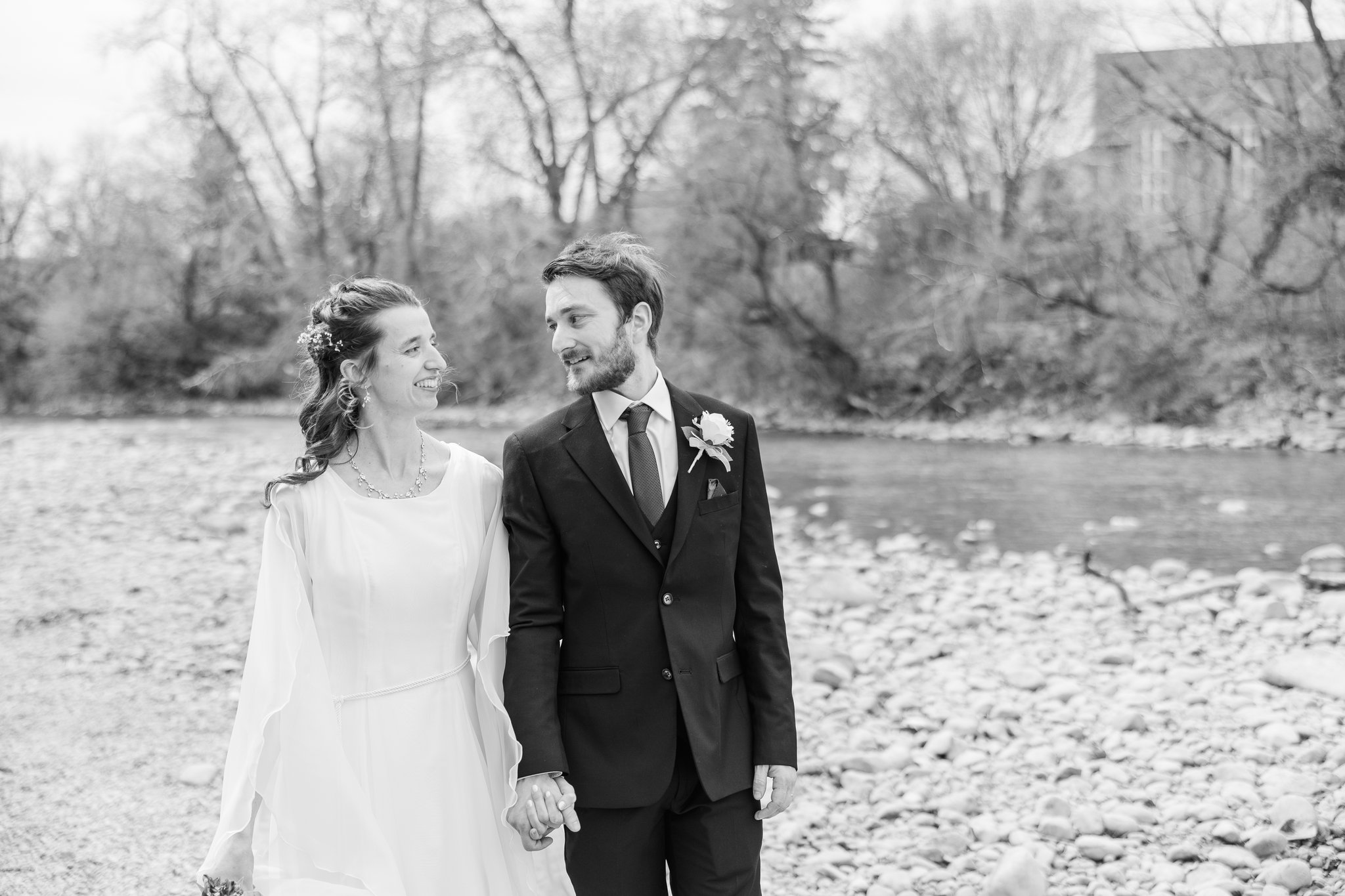 Bride and groom portraits beside the river near St. Mary's Cathedral Alberta