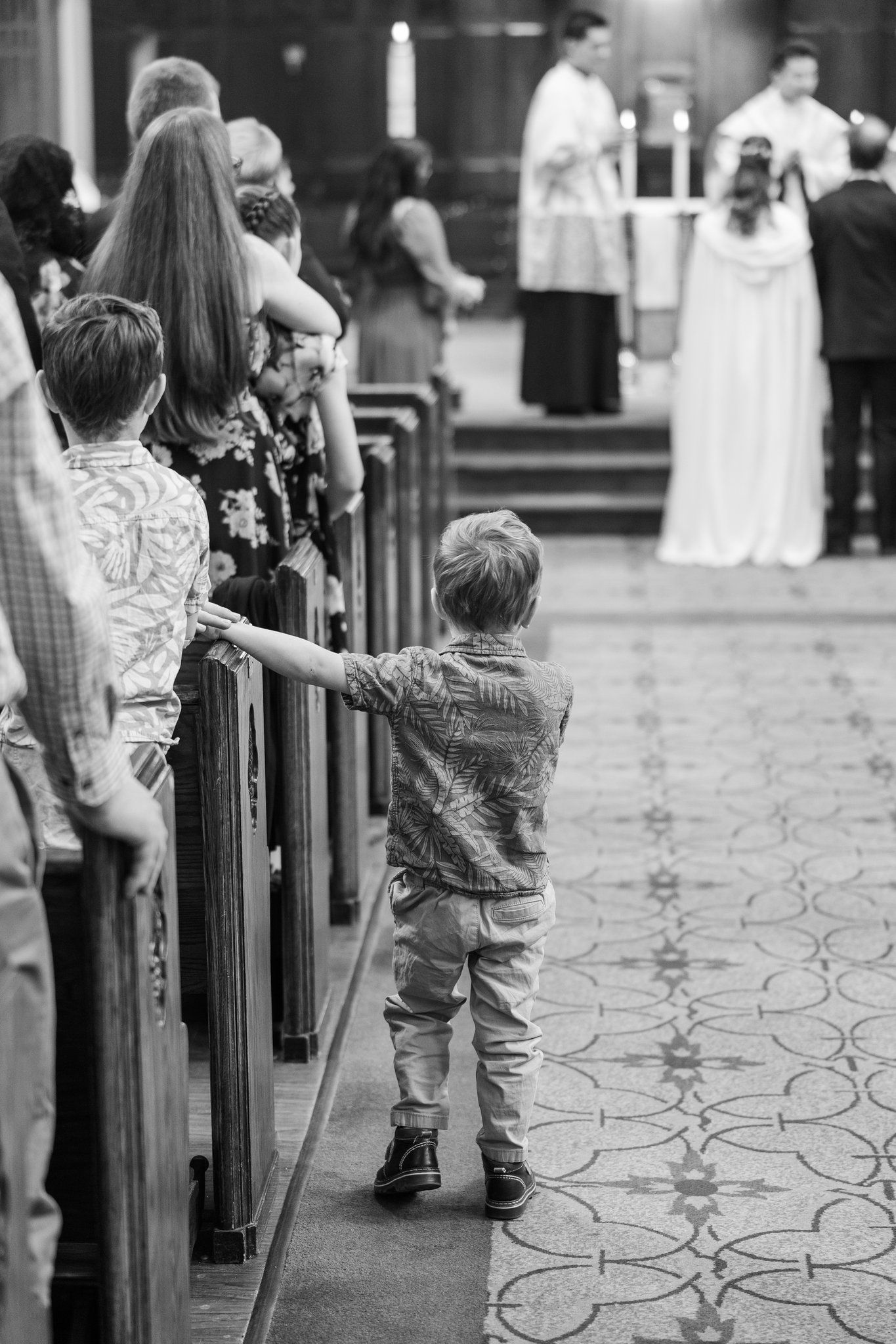 Gabriella and Daniel at the altar during their cathedral wedding ceremony in Alberta